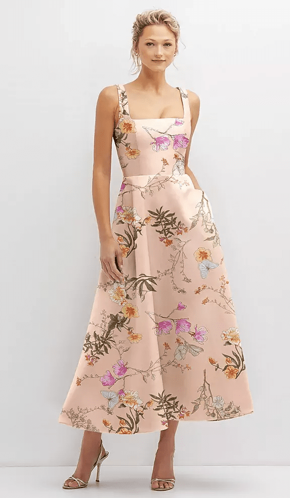 Model in a blush floral midi dress with square neckline and A-line skirt for bridal shower or wedding guest—Lakeside Bridal Traverse City, Michigan.